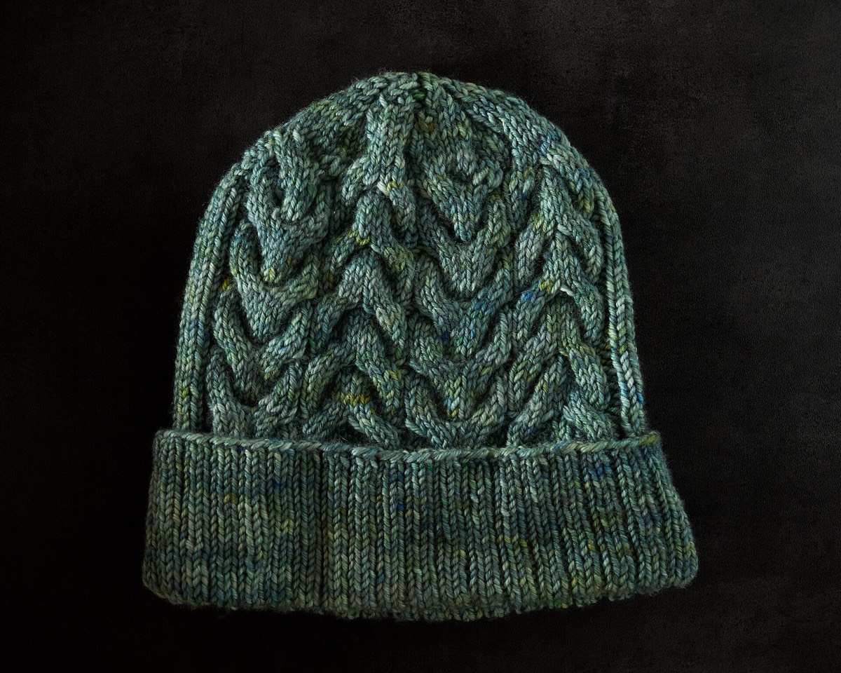 A hand-knitted hat with a cable stitch pattern