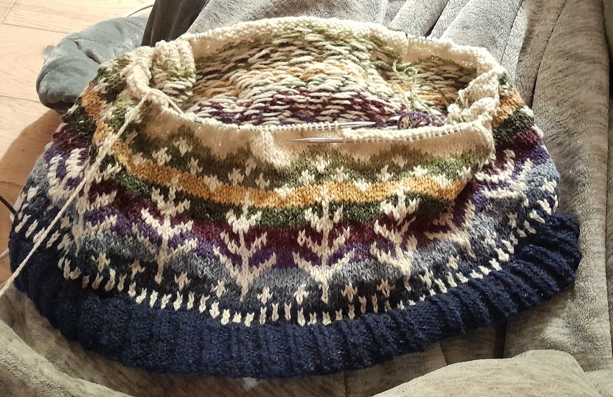 A stranded colourwork jumper in progress, showing the floats on the wrong side
