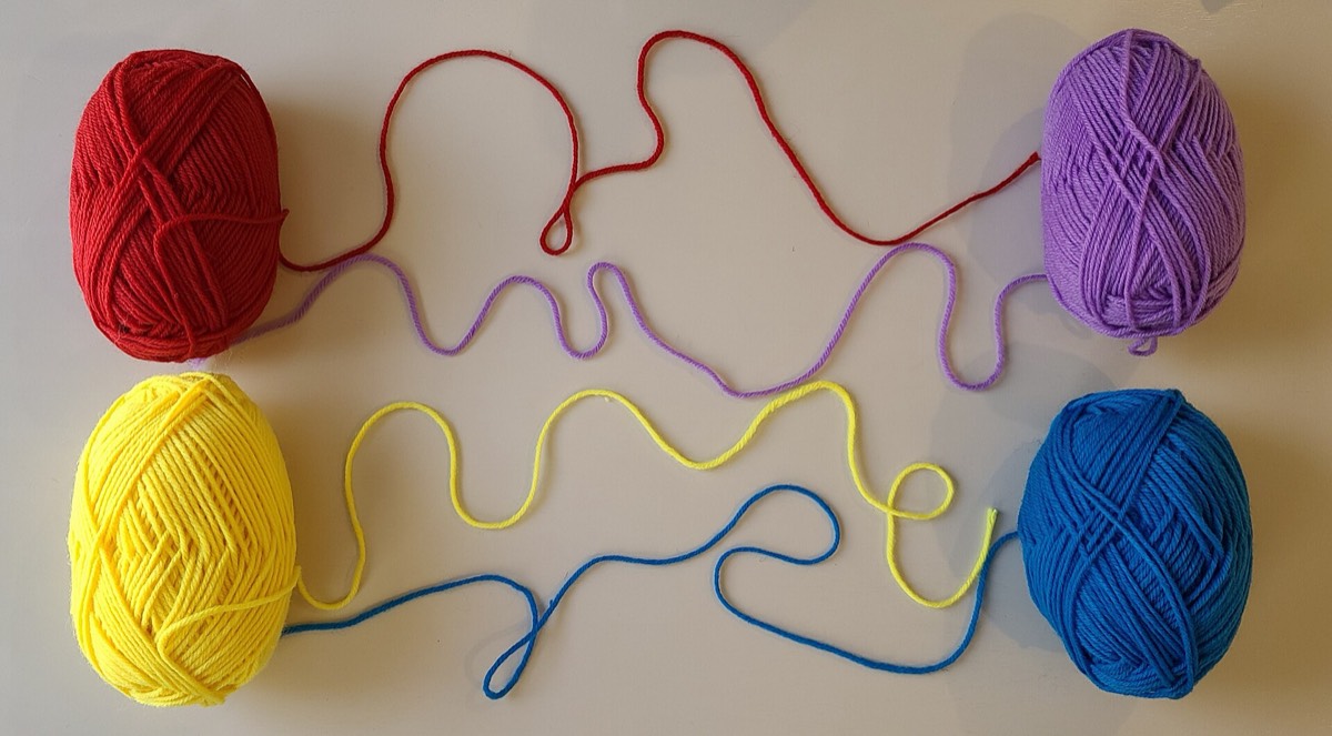 Several balls of yarn partially unravelled