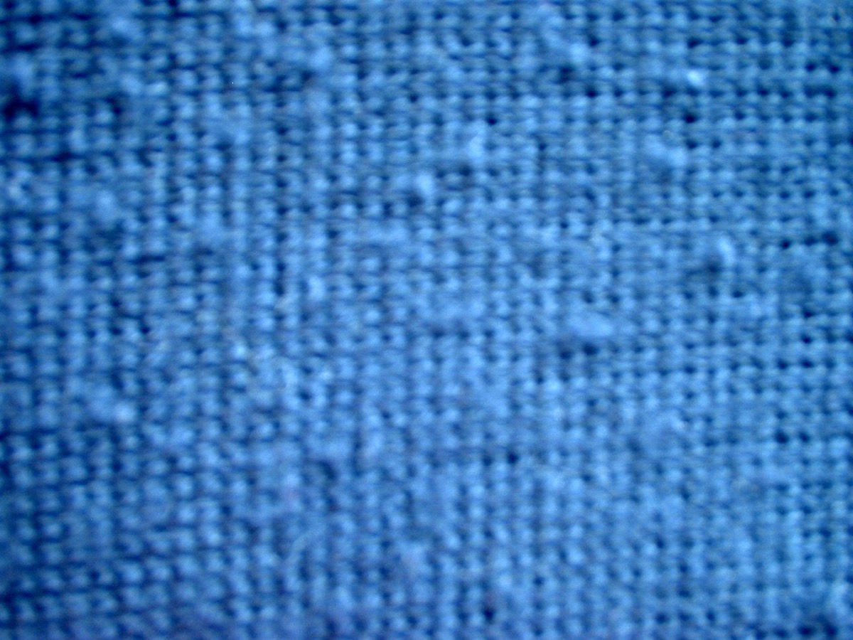 A knitted fabric with visible pilling on the surface