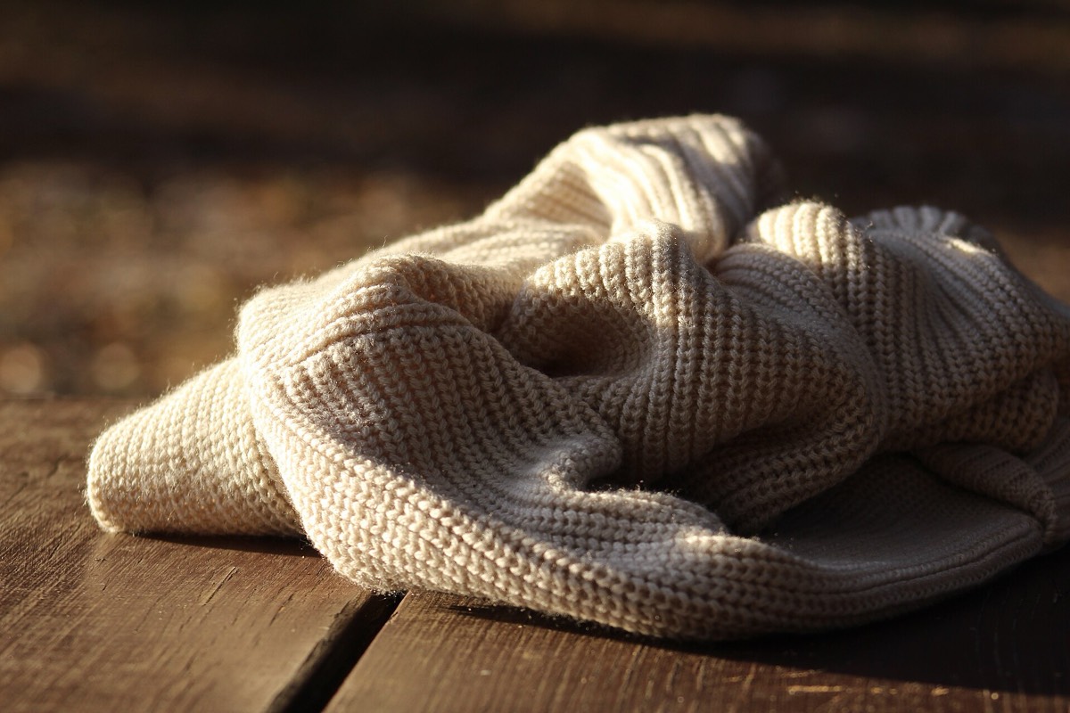 A knitted sweater worn as a light outer layer